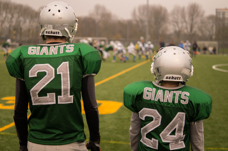 Canva – Two Giants Players Standing Outside Field